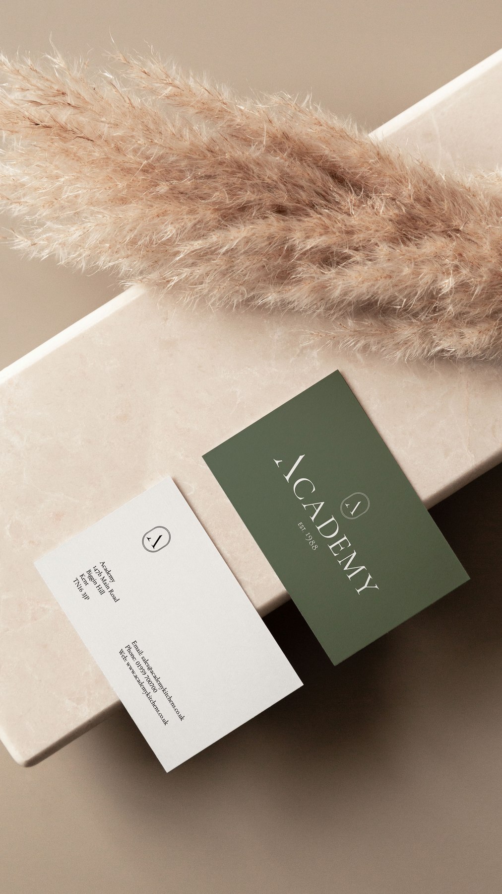 Academy Kitchens business cards in sage green and off-white with the A logomark, brand identity by HDEY