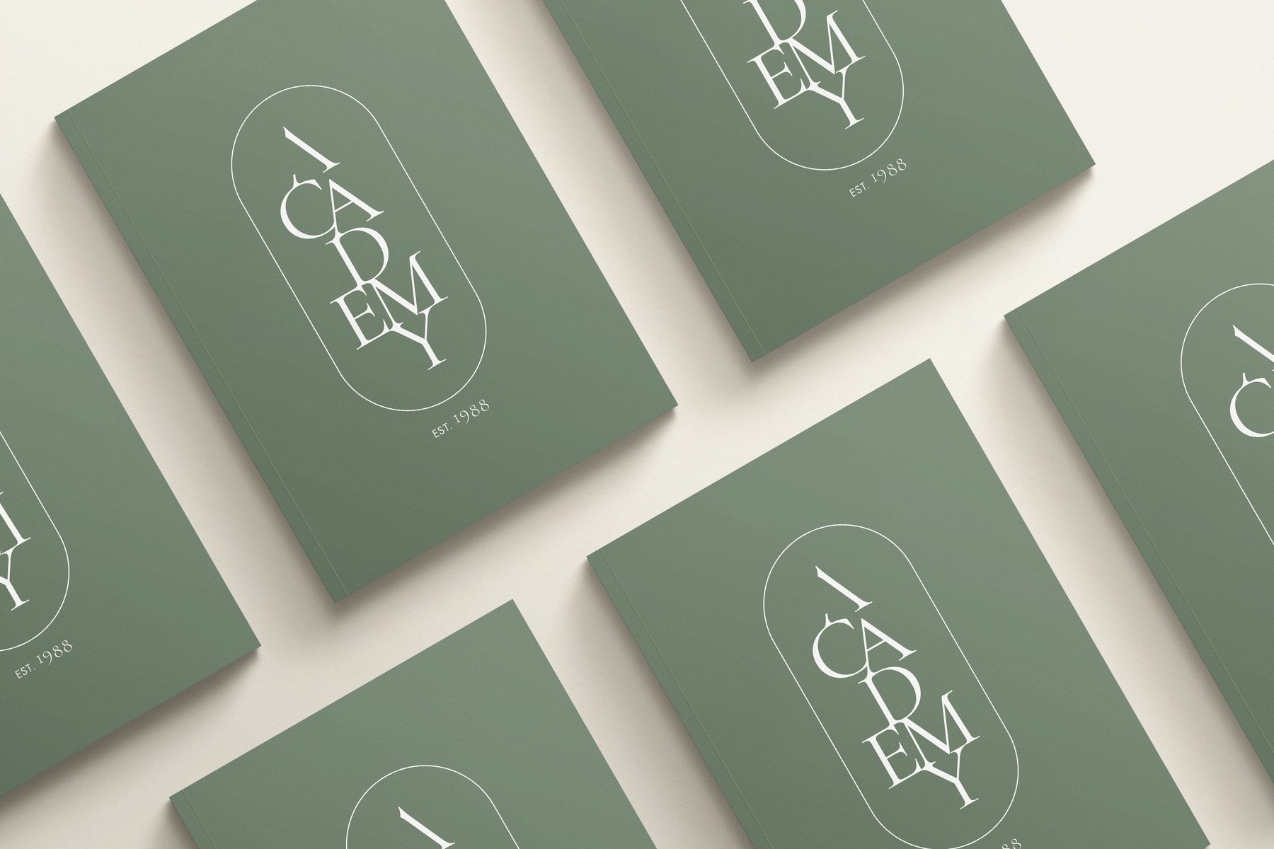 Academy Kitchens brochure covers repeated in sage green with the vertical logotype, brand identity by HDEY
