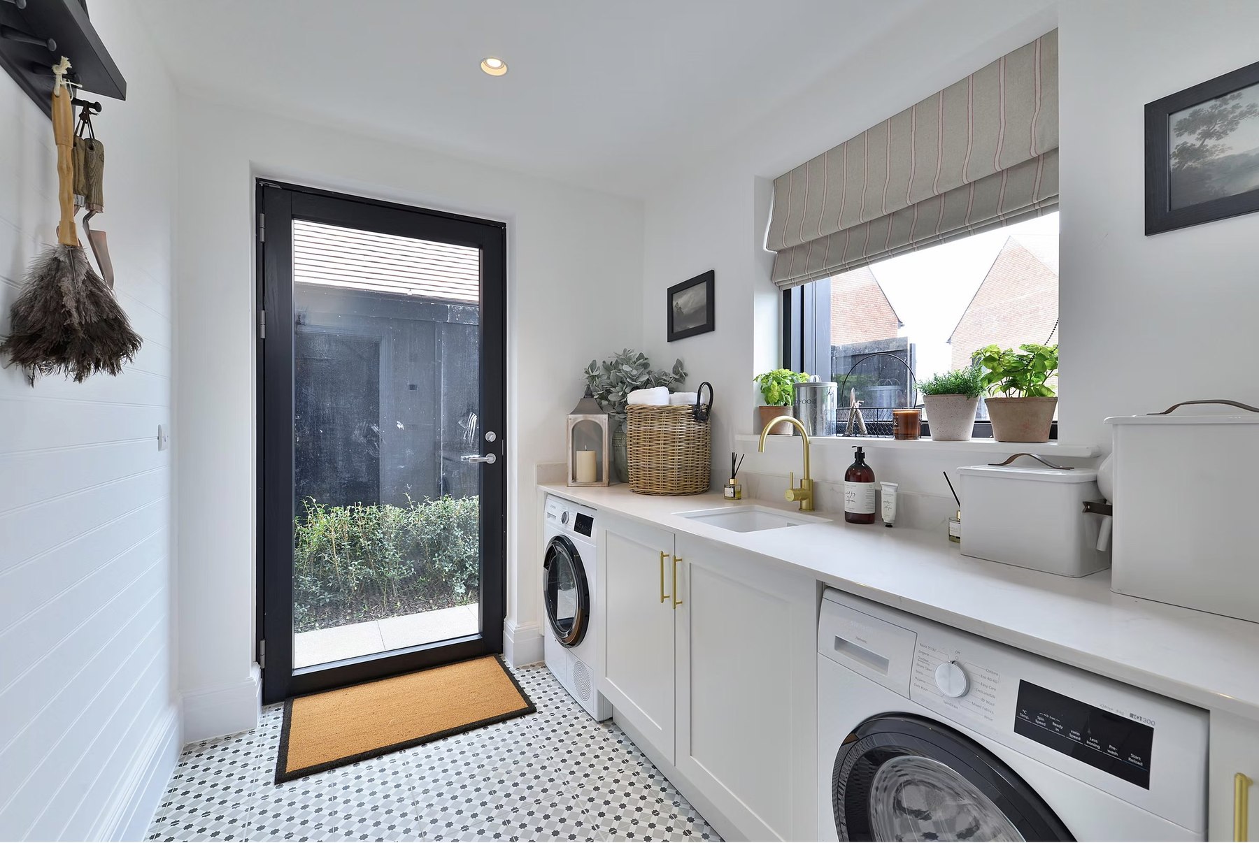 Alfold Gardens completed utility room with patterned floor tiles and garden access, Surrey — by HDEY