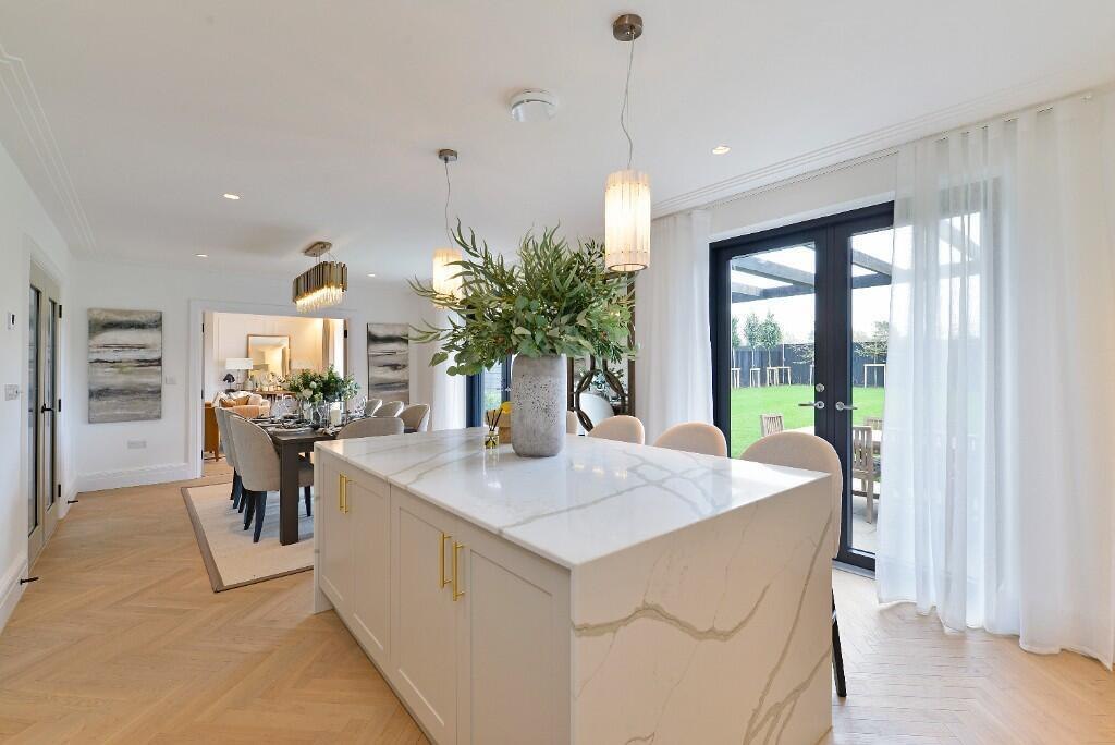 Alfold Gardens completed kitchen and dining area with marble island and gold hardware, Surrey — by HDEY
