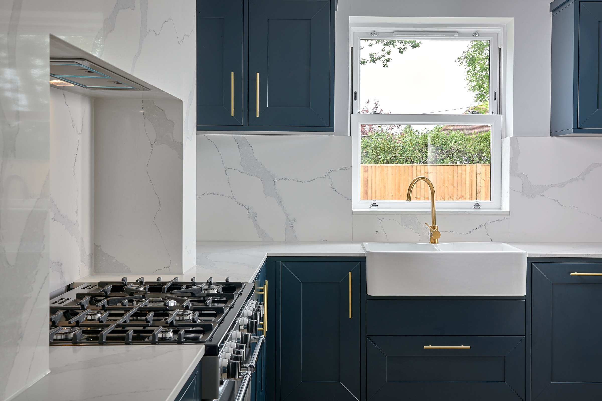 Brompton Gardens completed kitchen with navy Shaker units, range cooker and Belfast sink, West End, Woking