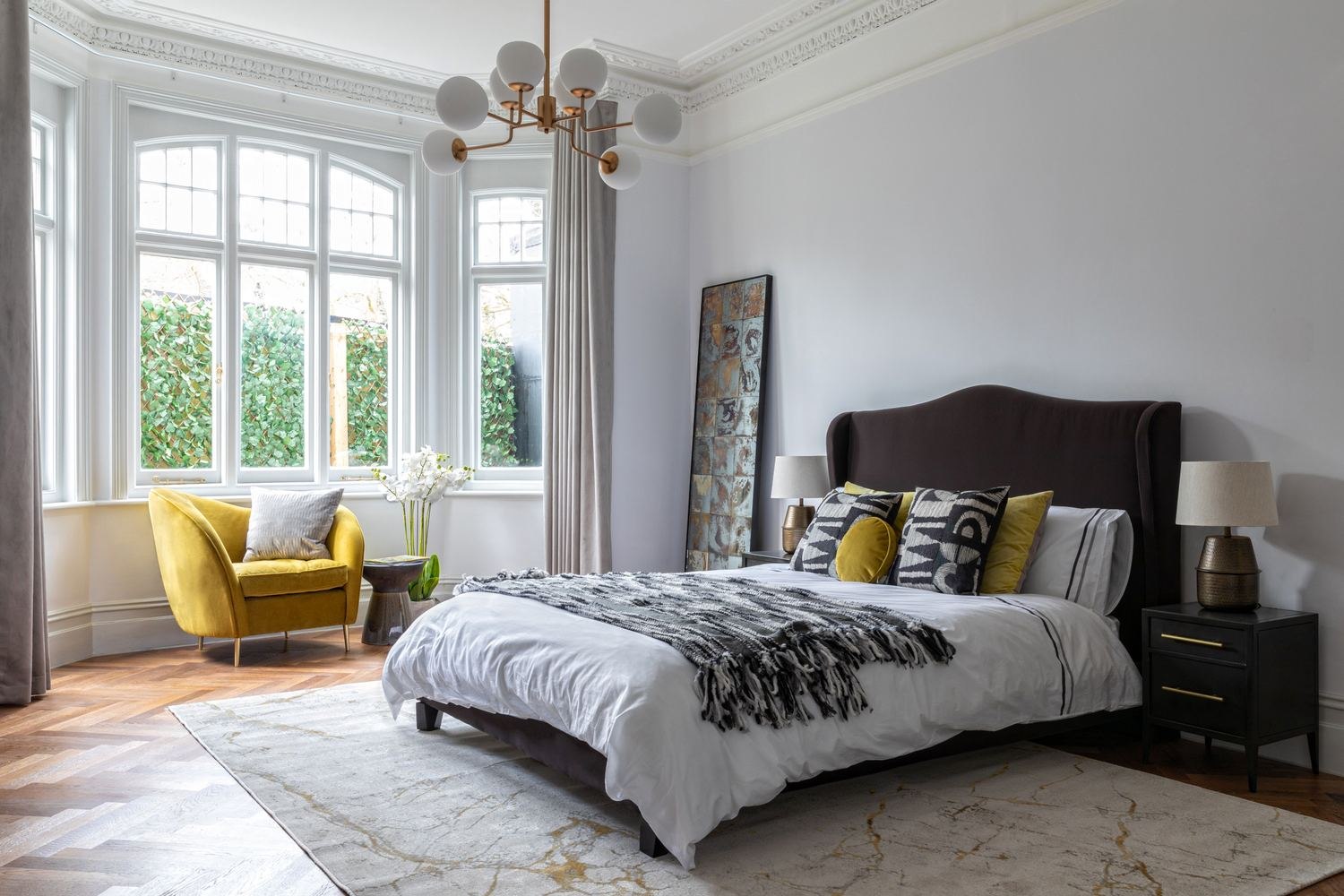 The Chalk Lane Residences show home bedroom with a yellow chair in the bay window, Epsom — styled by HDEY