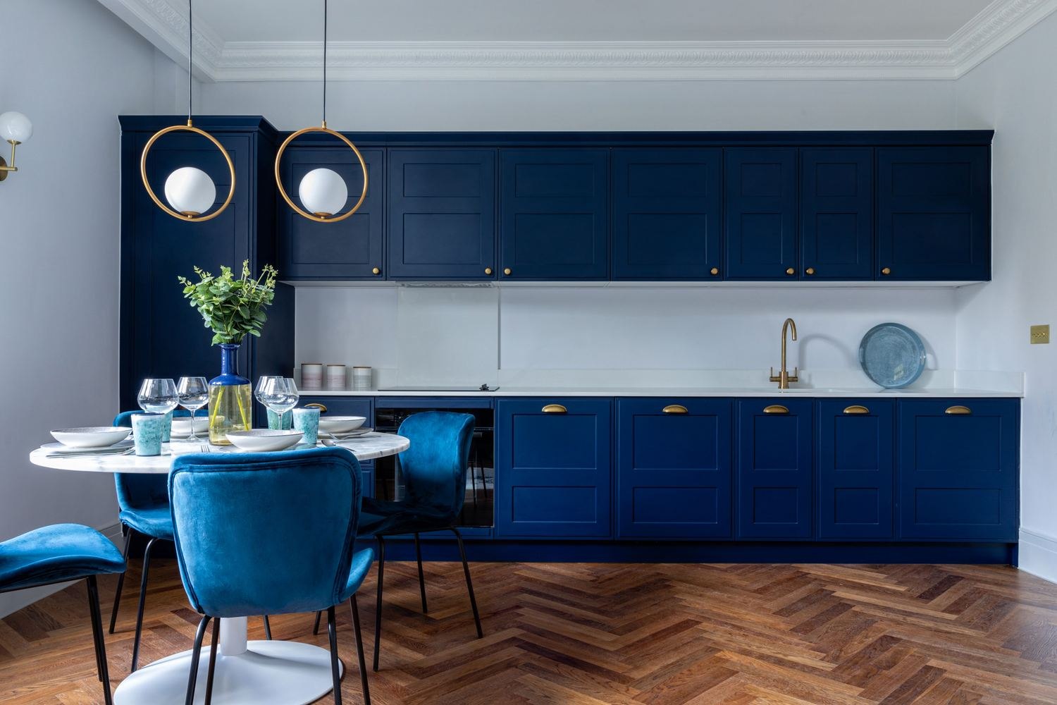 The Chalk Lane Residences show home kitchen with navy cabinetry and herringbone flooring, Epsom — by HDEY