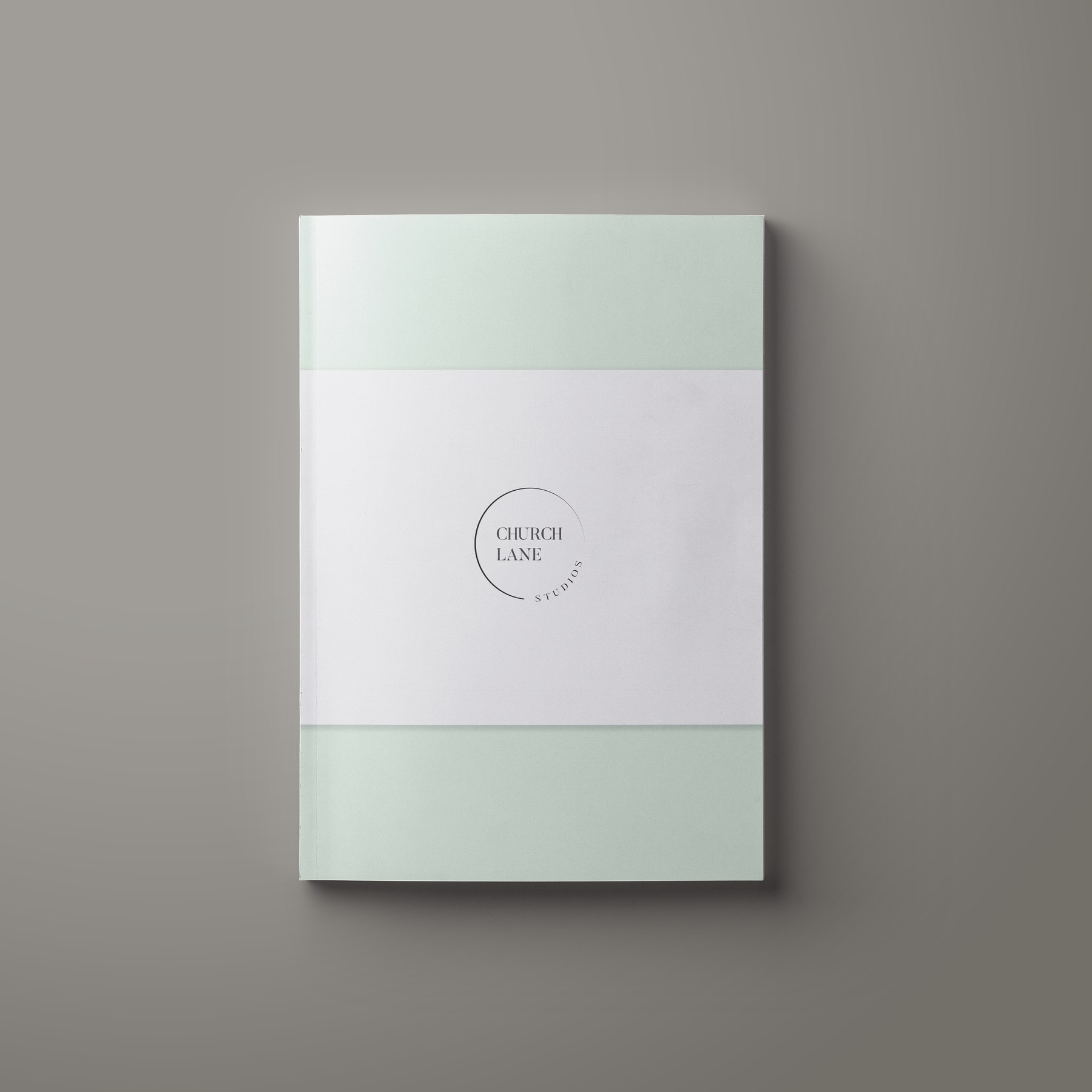 Church Lane Studios brochure cover in sage and white with the circular mark on a belly band, print design by HDEY
