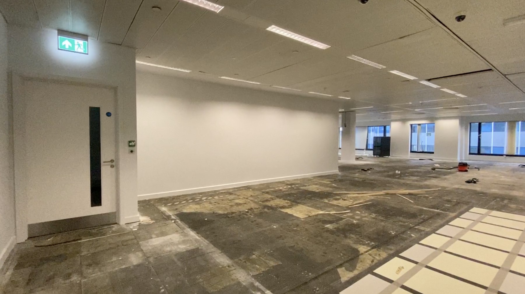 The vacant upper-floor unit at City Place House as tenants would have viewed it — bare floor plate with the previous fit-out removed, City of London