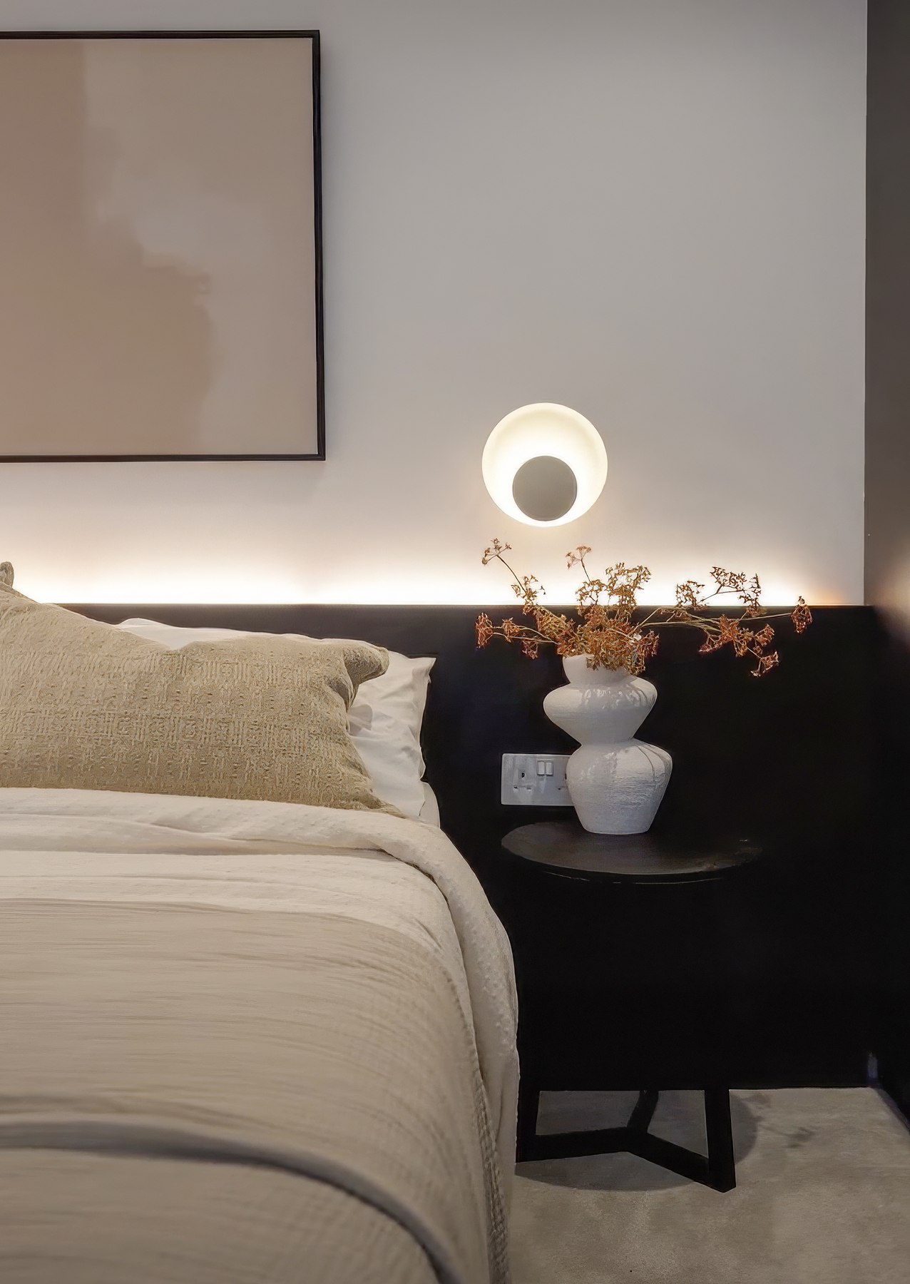 Ealing Broadway show home bedroom as built, with the dark headboard band, concealed lighting and a floating bedside table, West Ealing W13