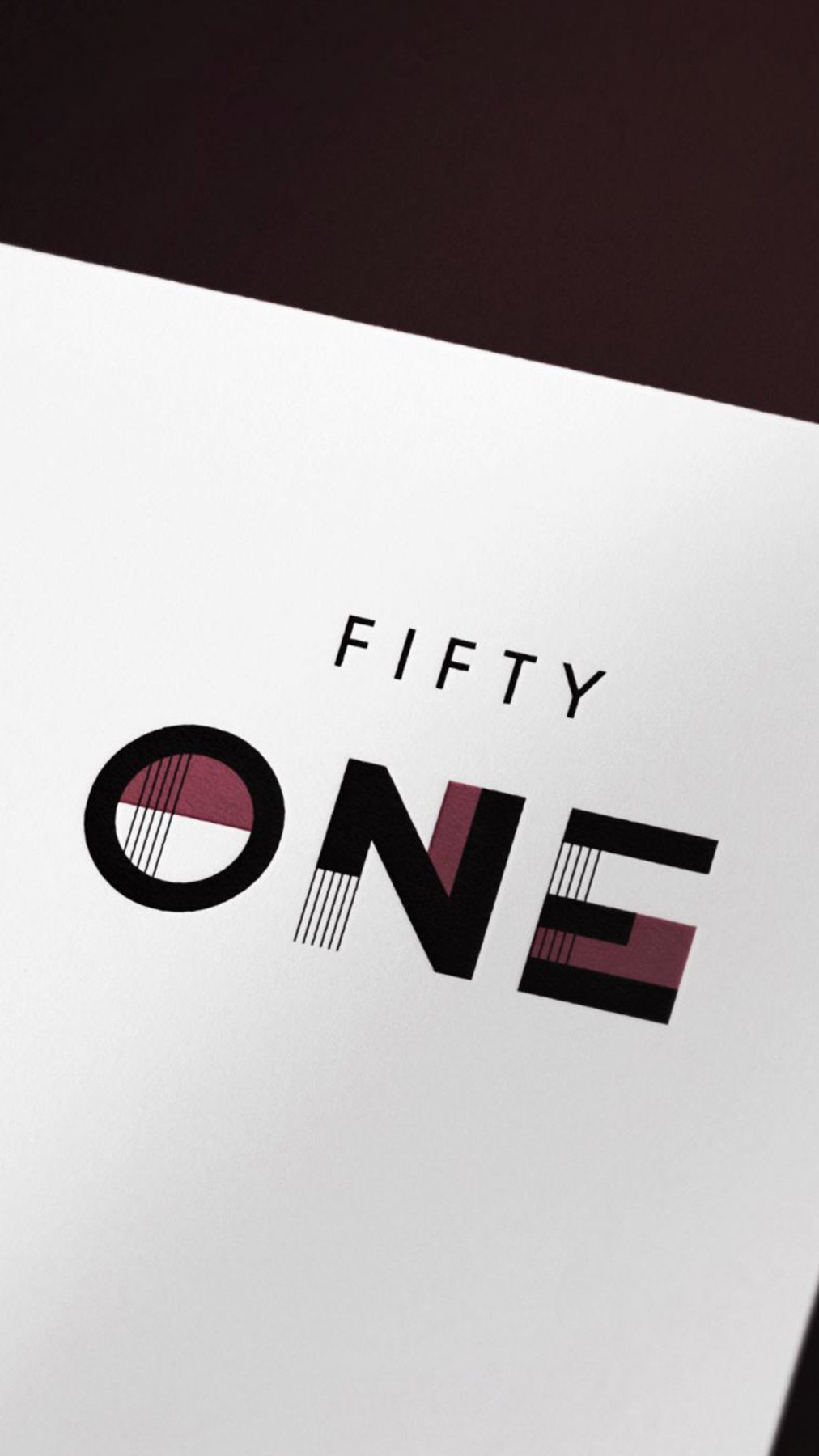 Fifty One logotype with FIFTY set above ONE, cut through with fine vertical rules and burgundy blocks, brand identity by HDEY