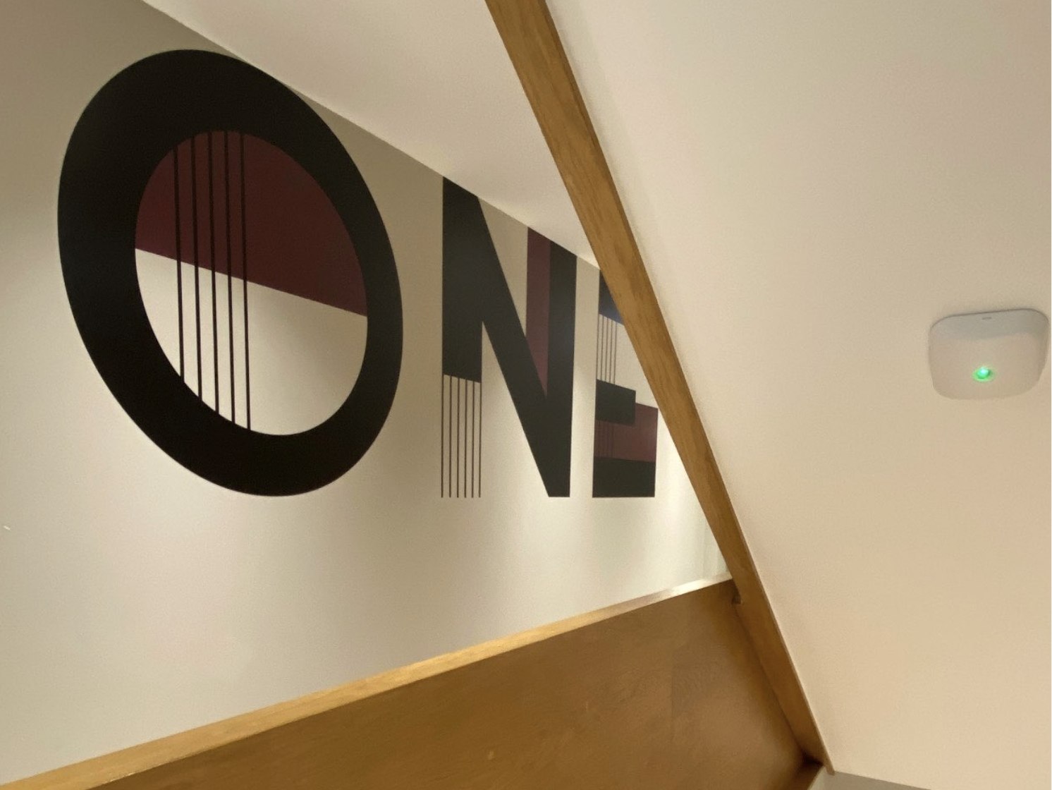 Fifty One communal stair wall with ONE painted large in black and burgundy, Ealing — wall graphics by HDEY
