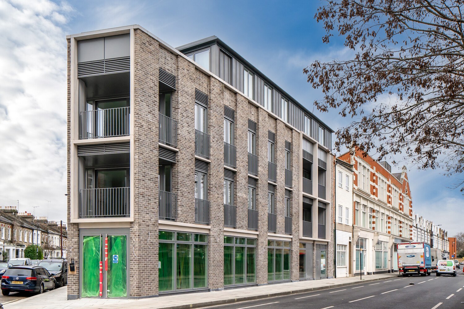 Hannell House exterior on Dawes Road — brick and glazed green tile frontage, Fulham