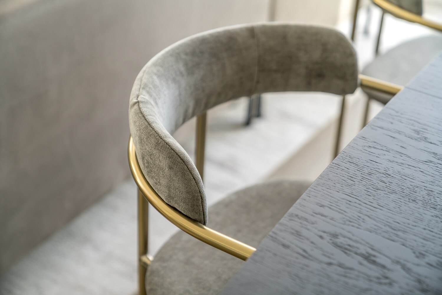 Hannell House show home detail — velvet dining chair against a stone table edge, Fulham, by HDEY