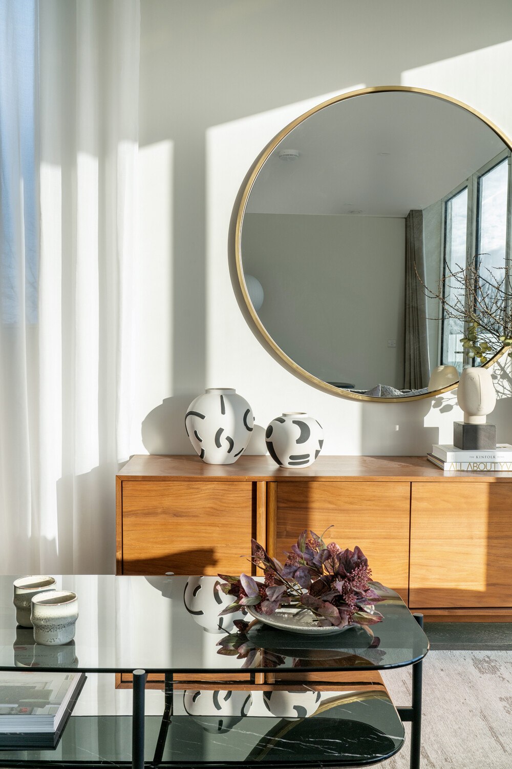 Hannell House show home walnut sideboard with ceramics and round brass mirror, Fulham, by HDEY