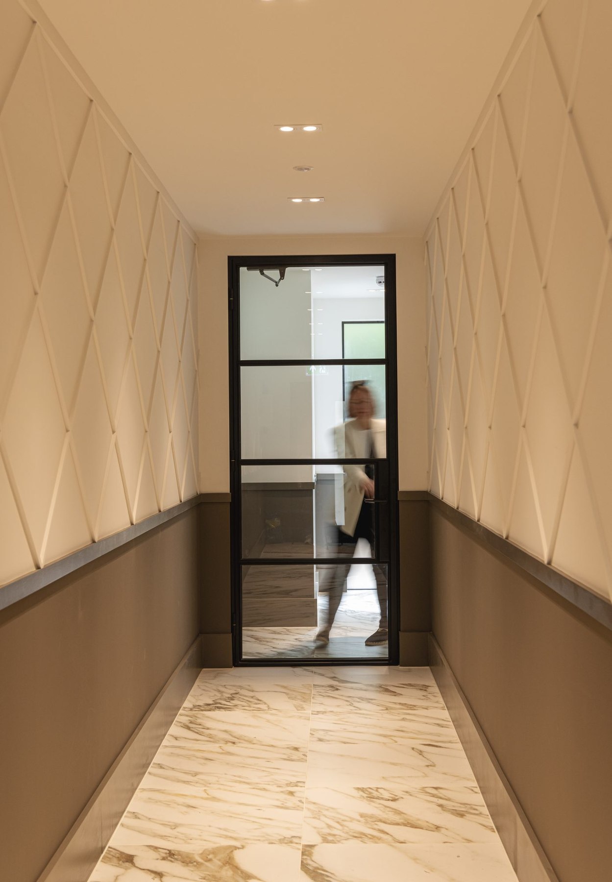 Ivy Gardens entrance hallway with marble flooring and Crittall-style glazed door, Ealing — interior design by HDEY