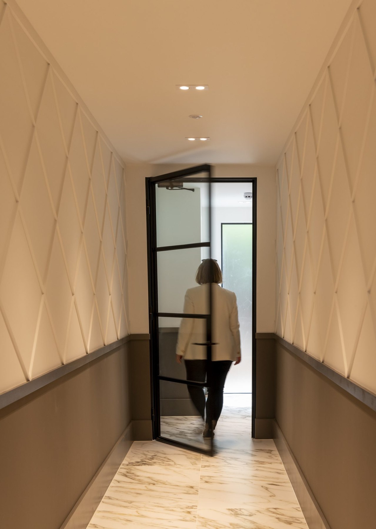 Ivy Gardens hallway with textured wall panelling and Crittall glazed door, Ealing — interior design by HDEY