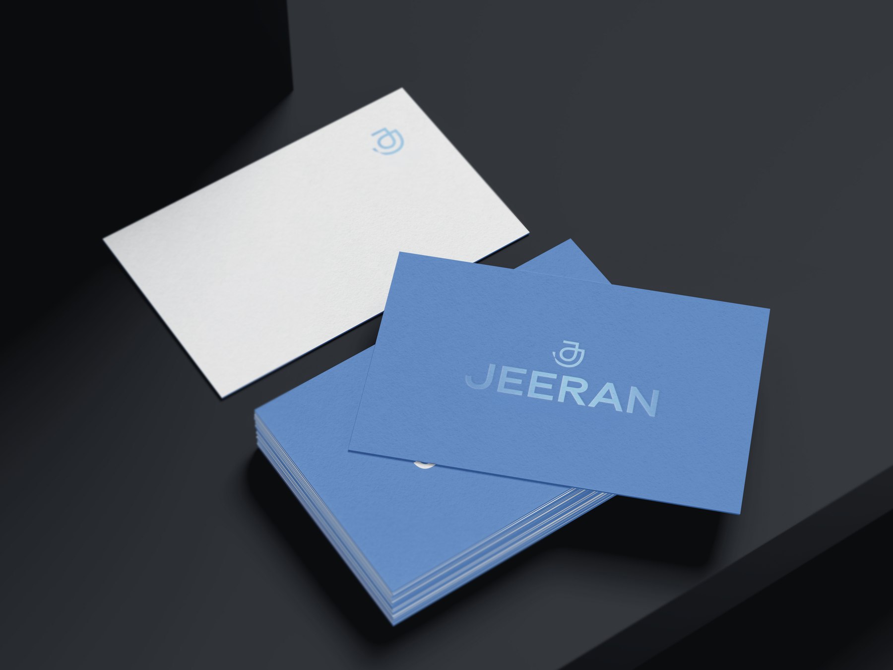 Jeeran business cards in cornflower blue and white with the logotype and monogram, brand identity by HDEY