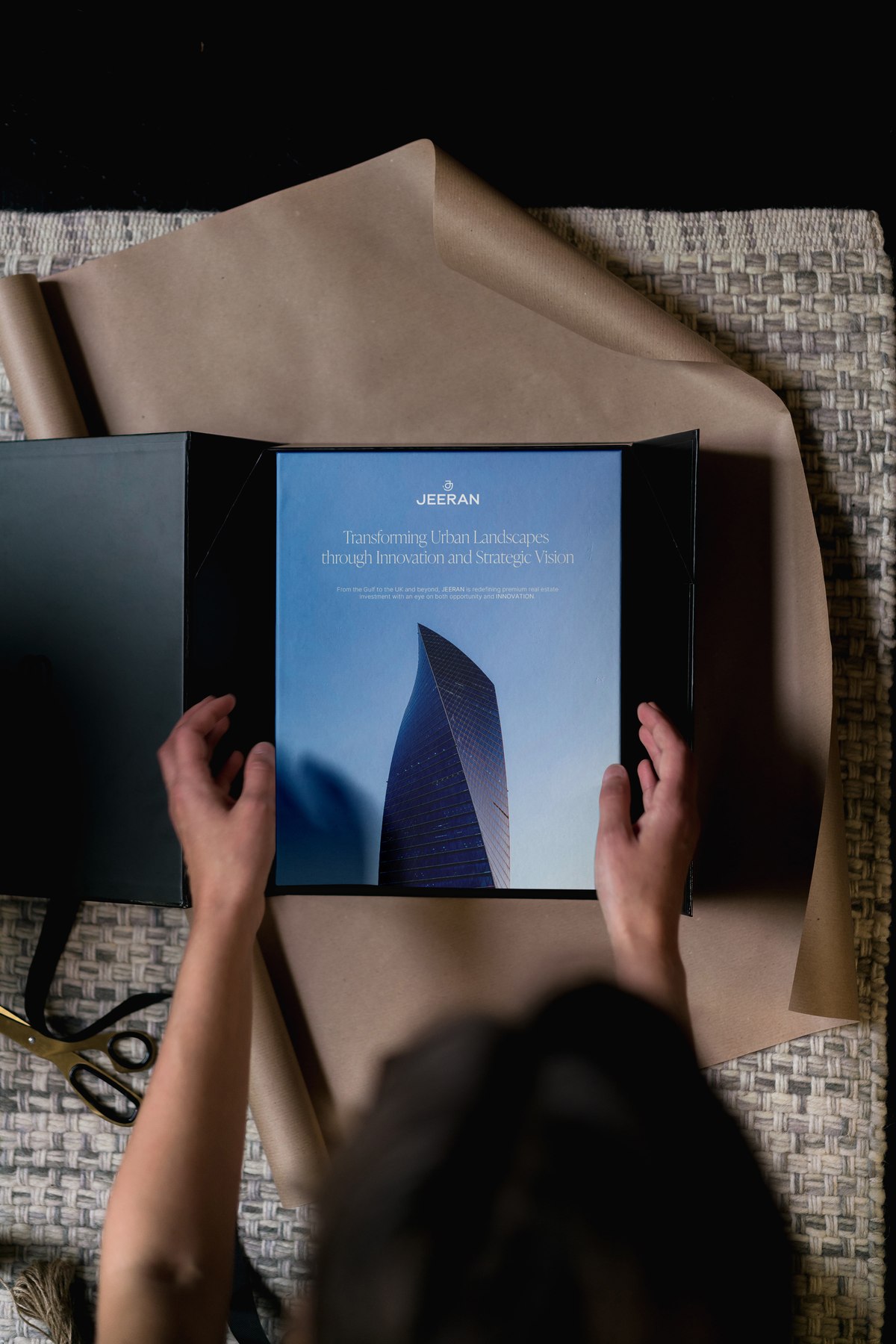 Jeeran presentation folder opened to show the brand document with the line Transforming Urban Landscapes through Innovation and Strategic Vision, design by HDEY