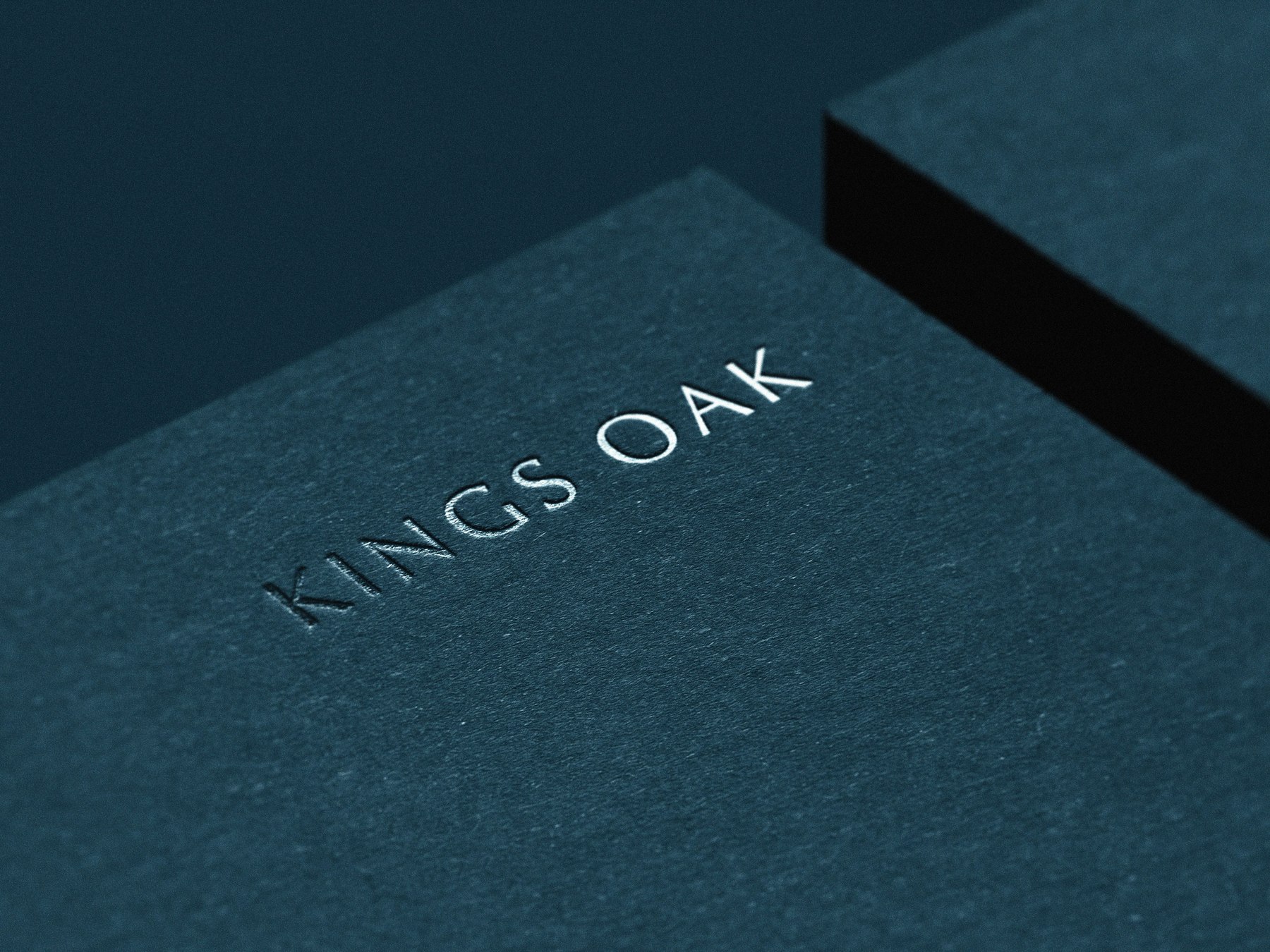 Kings Oak logotype blind embossed on off-white stock, brand identity by HDEY