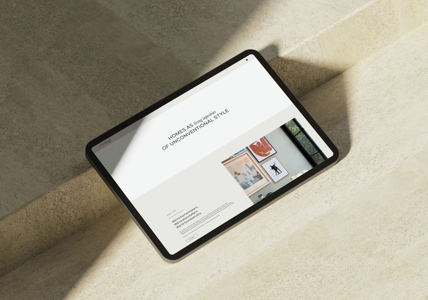 Luxgrove Homes website homepage shown on a tablet — web design by HDEY