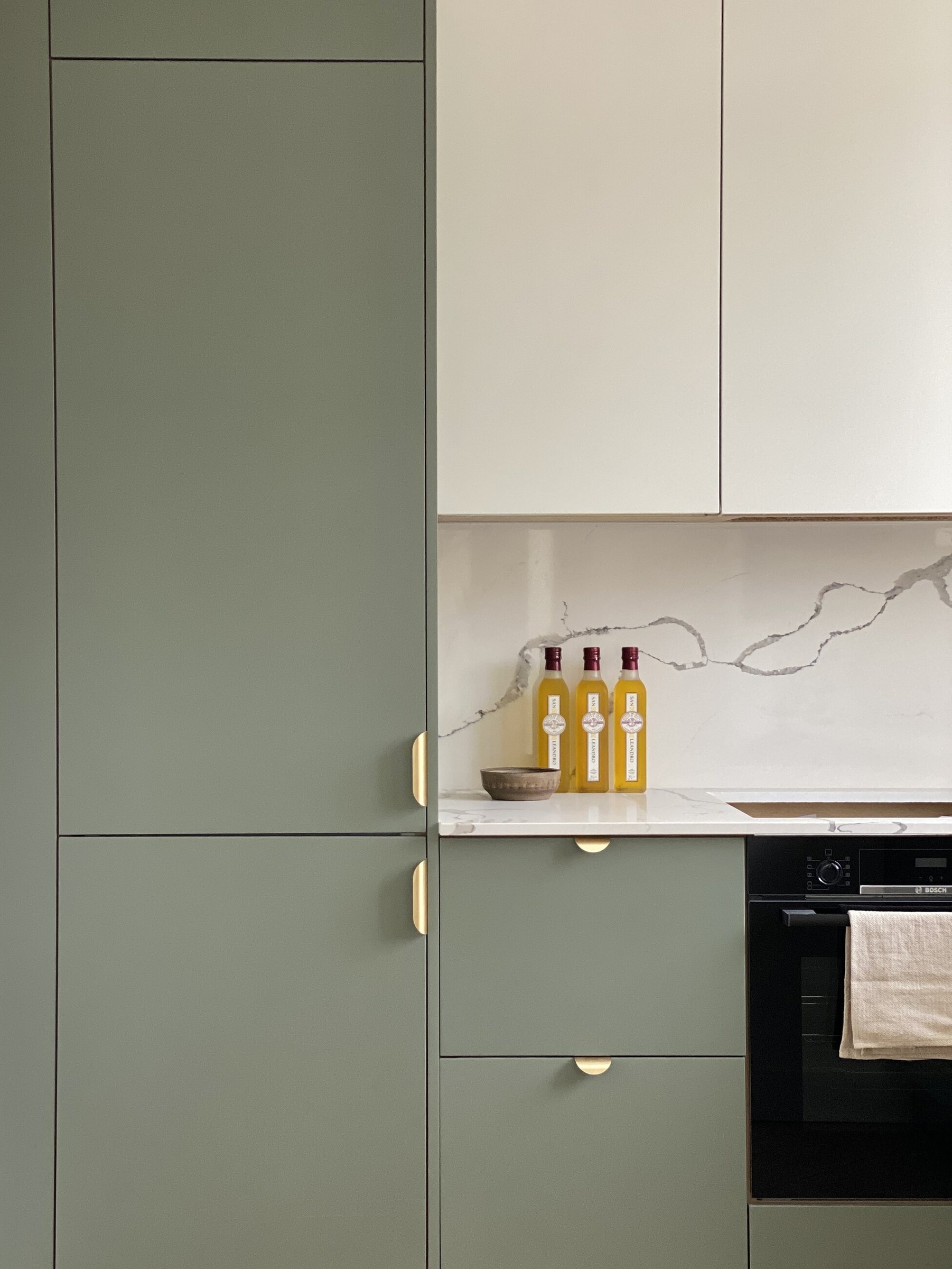Market Place full-height kitchen units in a bespoke green with integrated oven, Acton, by HDEY