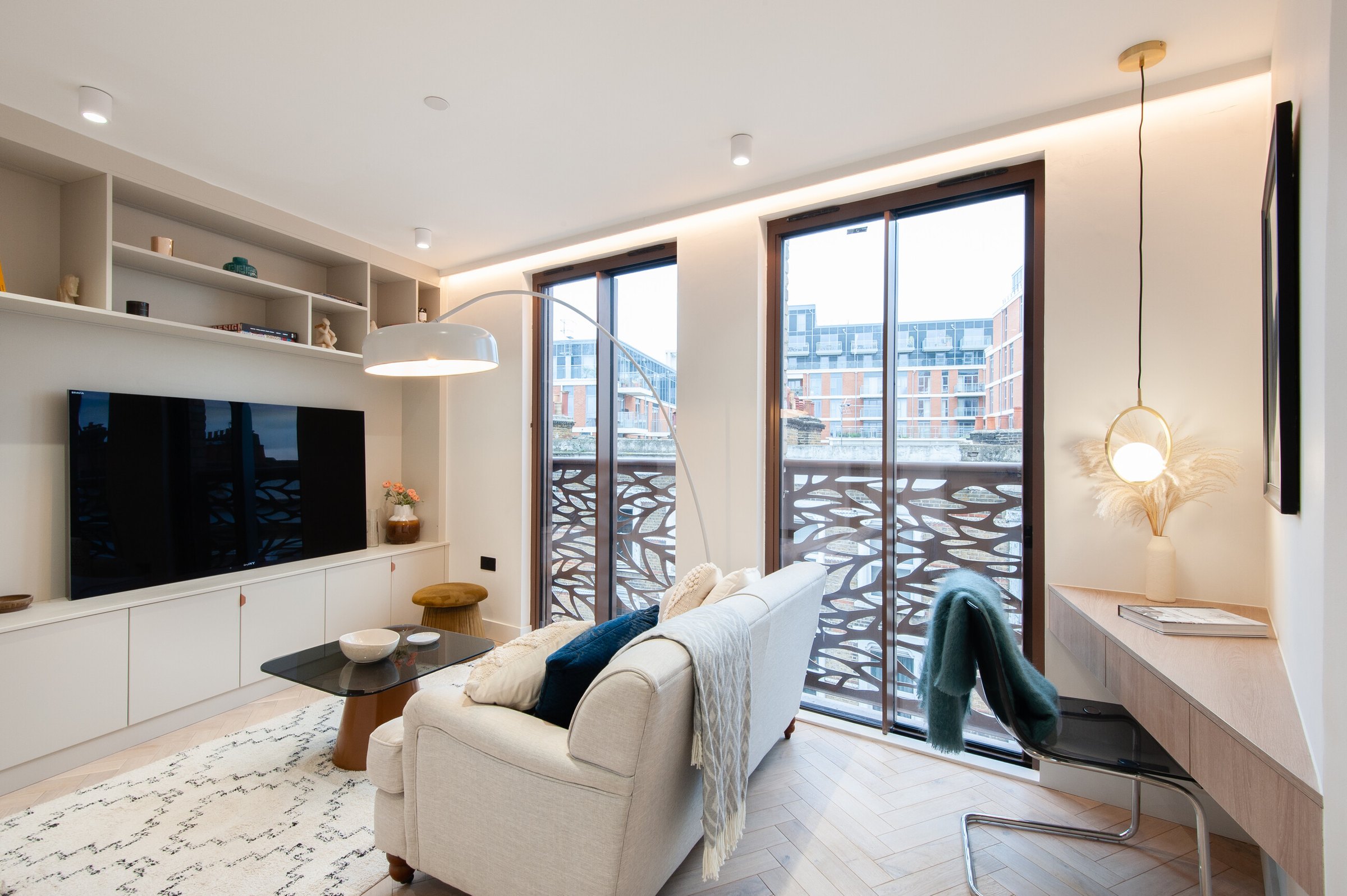 Market Place living room, Acton — full-height joinery and a desk run to the juliet balcony, interior design by HDEY