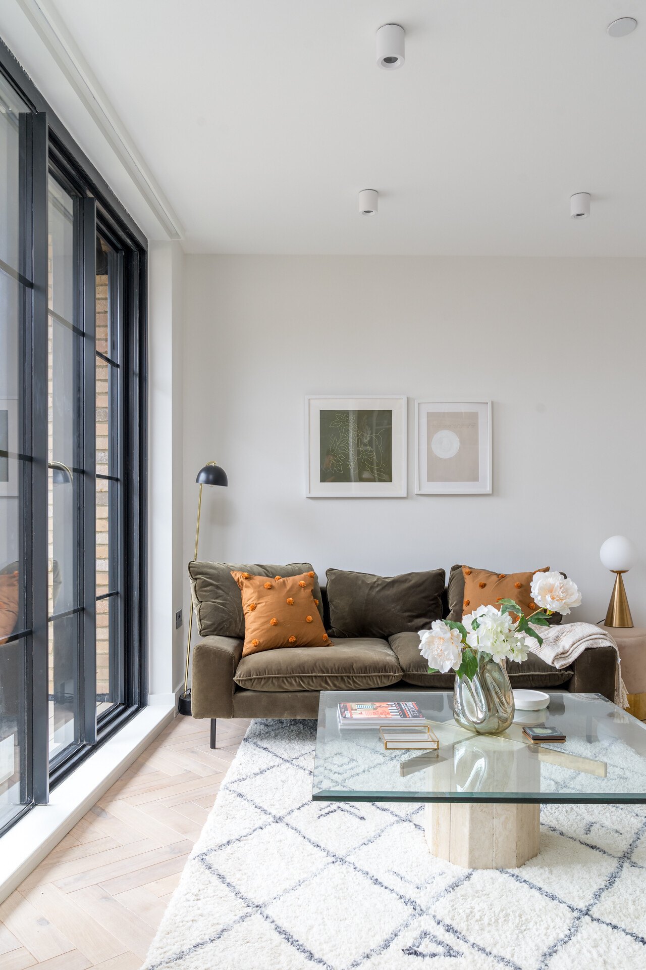 Market Place living room, Acton — sofa and glass table against the juliet balcony, interior design by HDEY