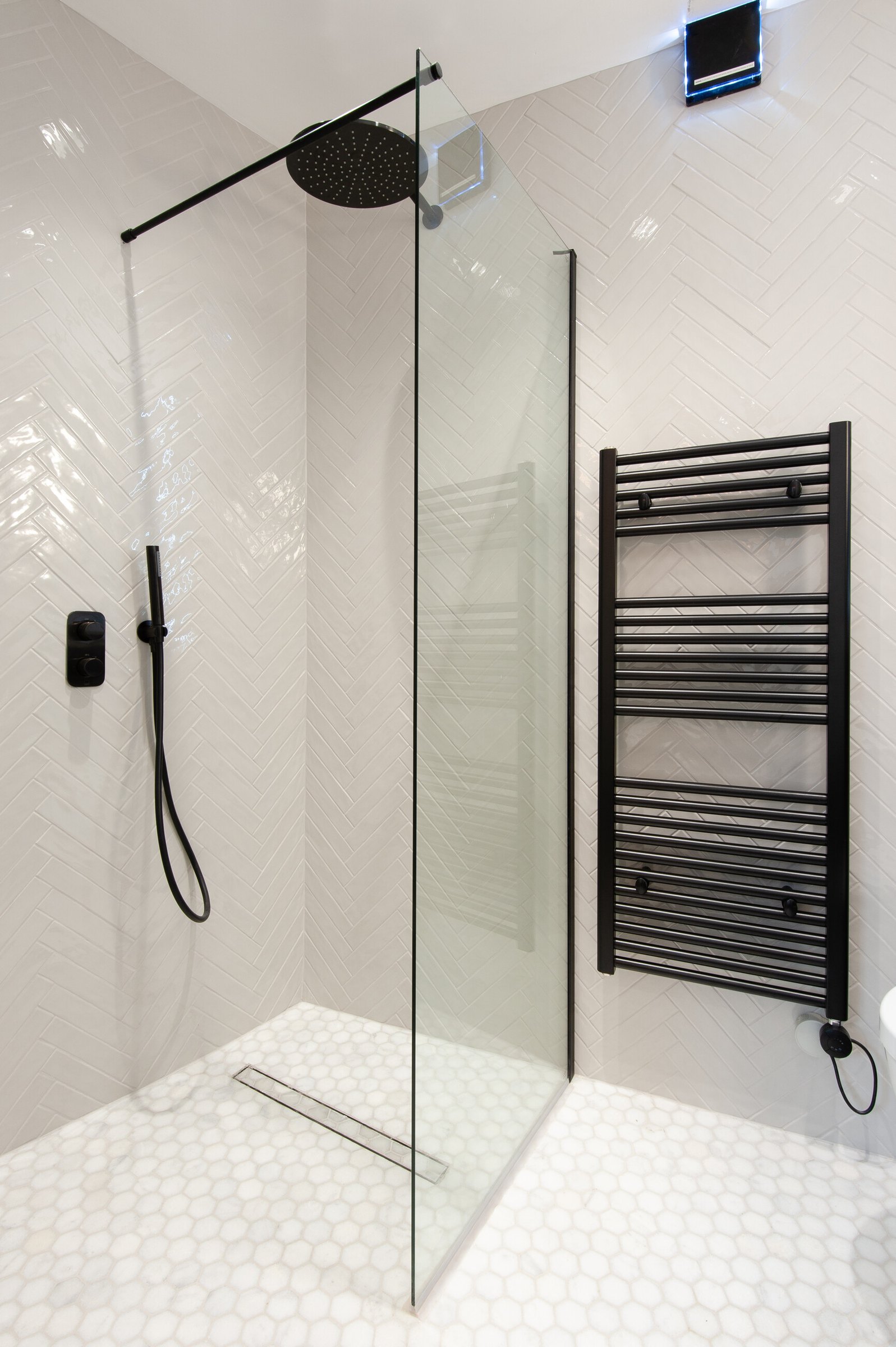 Market Place walk-in shower with black brassware and hexagonal floor tile, Acton, by HDEY