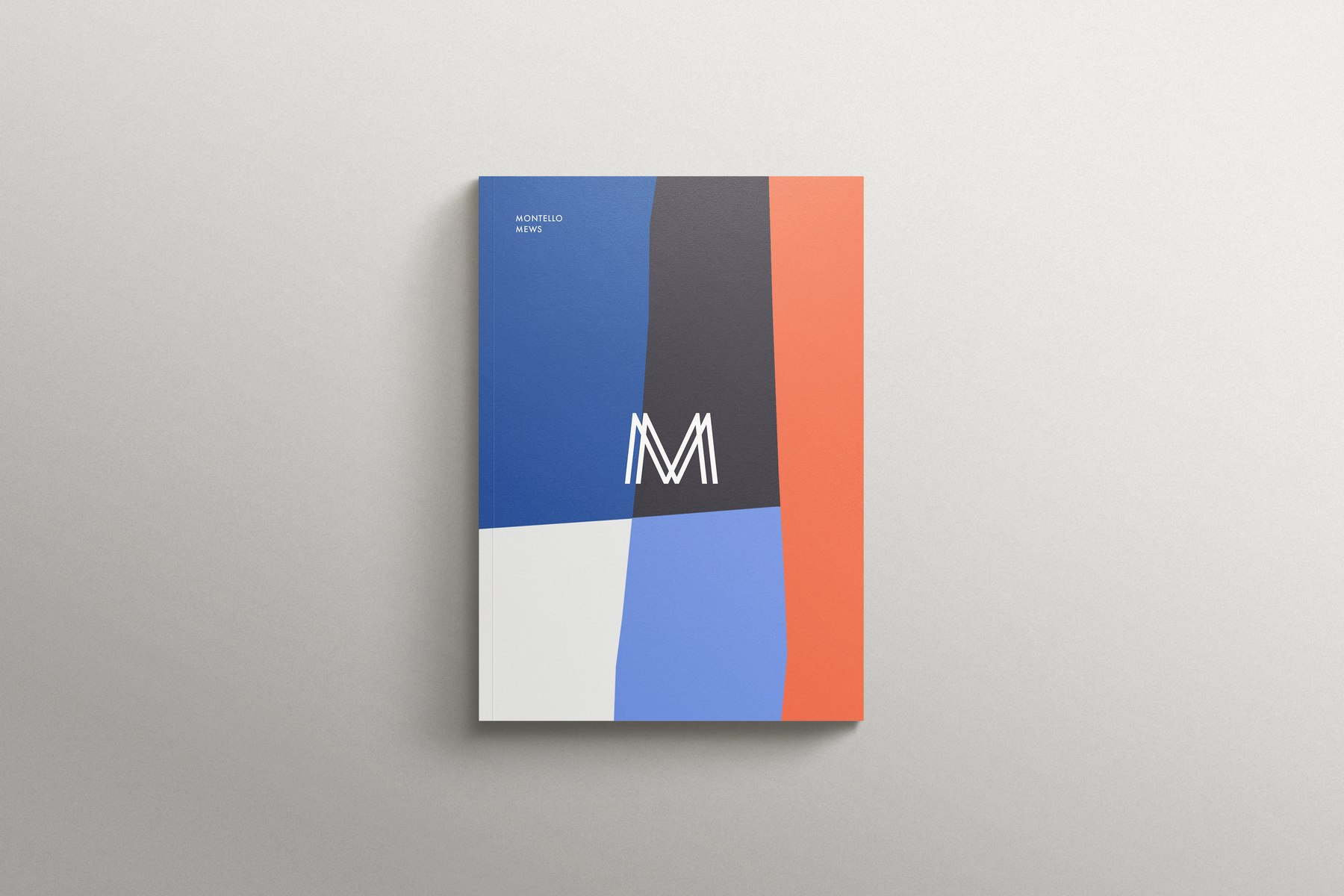 Montello Mews brochure cover in cobalt, charcoal and orange colour blocks with the white M monogram, print design by HDEY