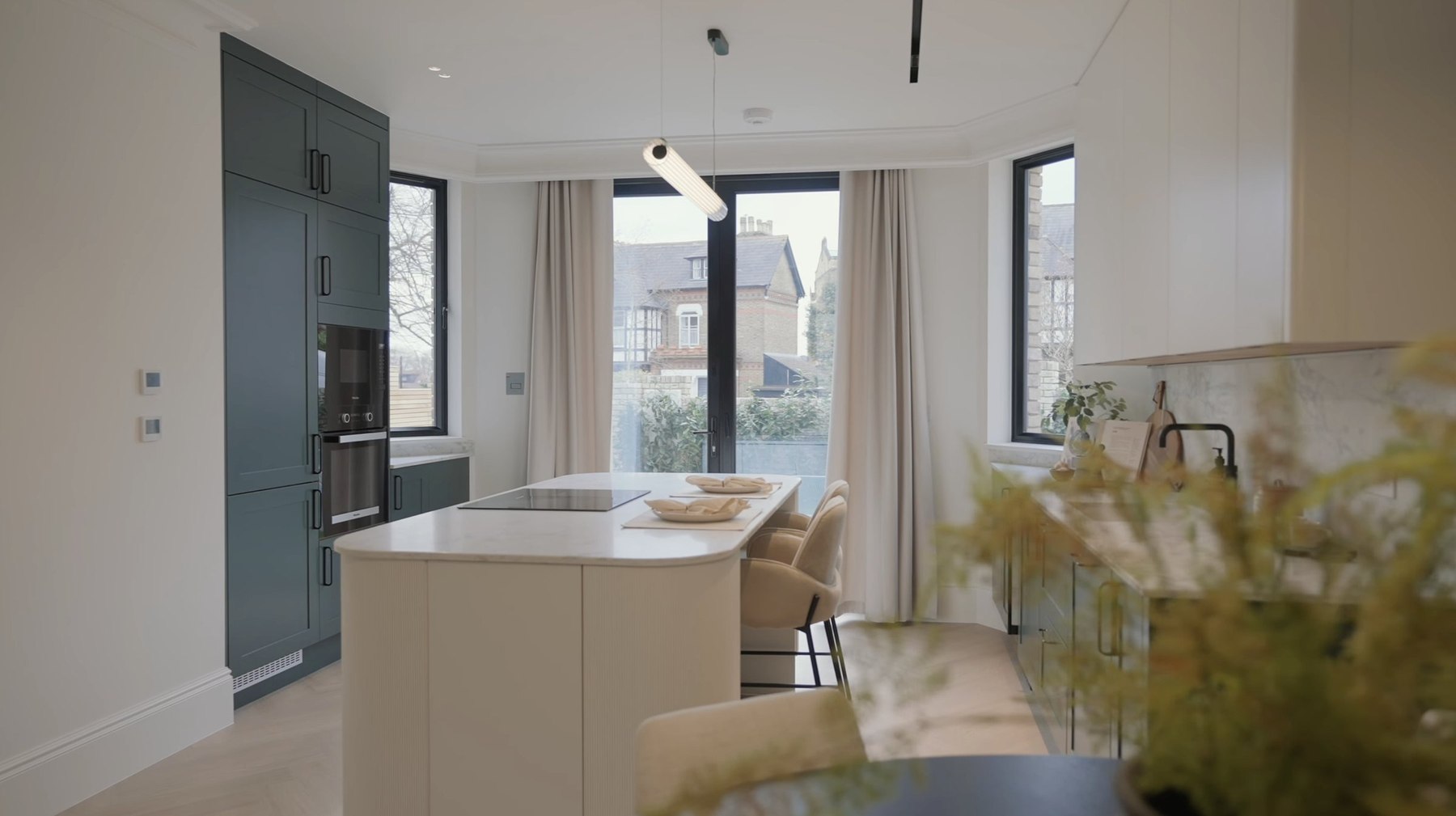 Montpelier Mews kitchen with green cabinetry, marble splashback and fluted island, Ealing — designed by HDEY