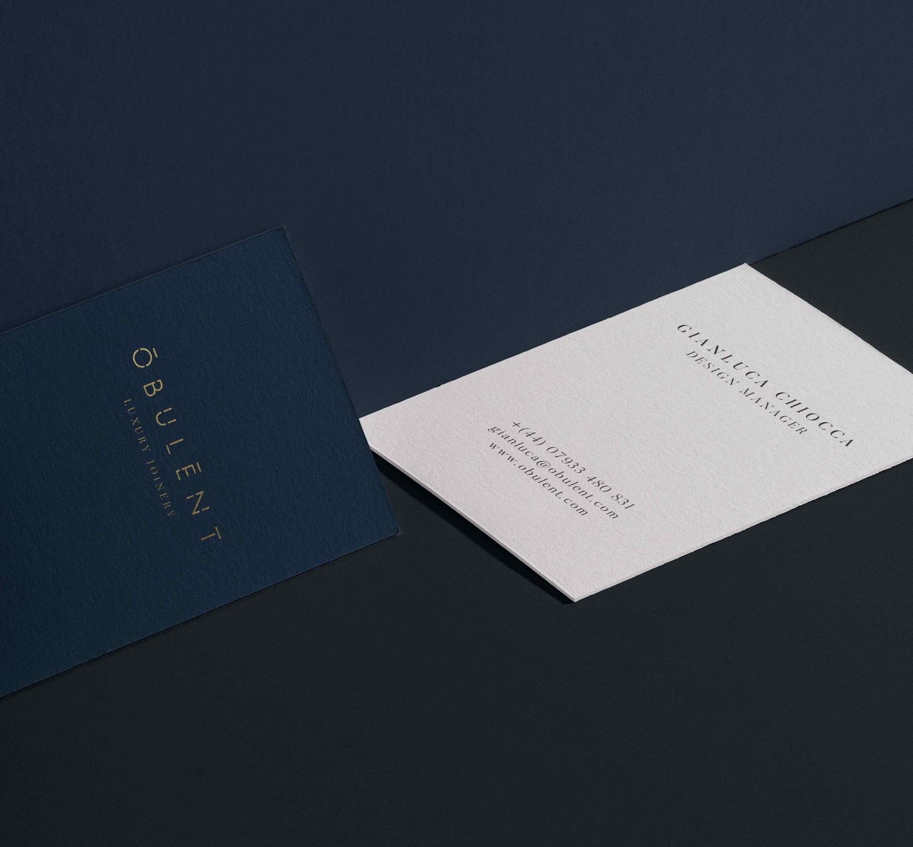 Obulent business cards in navy with the gold logotype and Luxury Joinery, and a white reverse with contact details — brand identity by HDEY