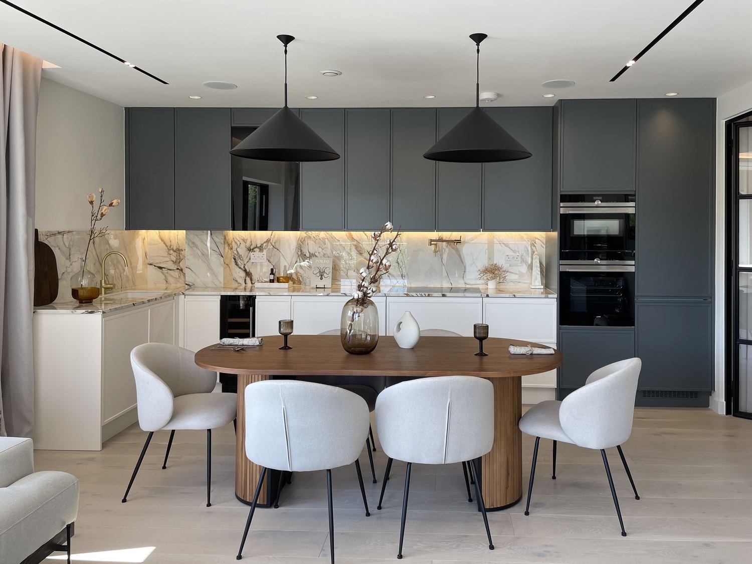 Queen's Park Residences kitchen with dark green cabinetry and marble-veined island, NW6 — interior design by HDEY