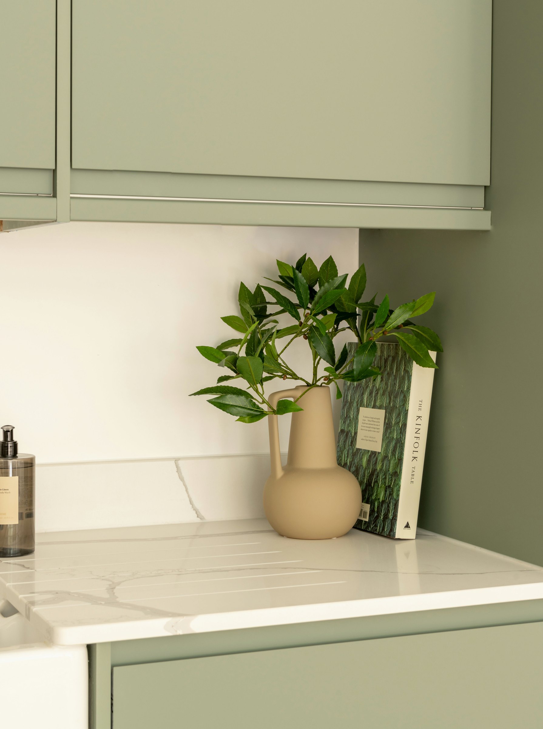 Robson Road show home utility with sage green cabinetry and stone worktop, West Dulwich, styled by HDEY