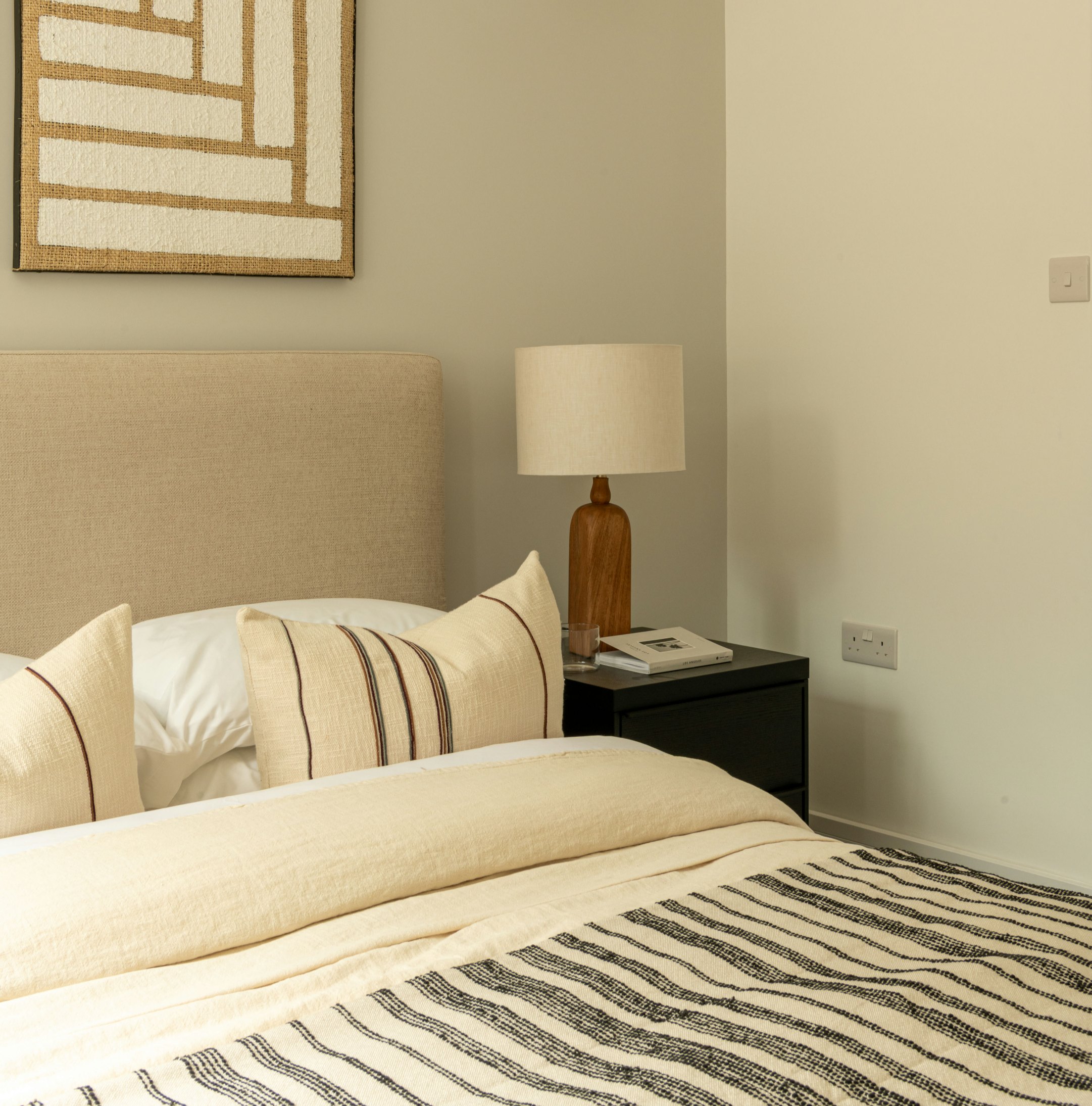 Robson Road show home bedroom with upholstered headboard and striped throw, West Dulwich, styled by HDEY