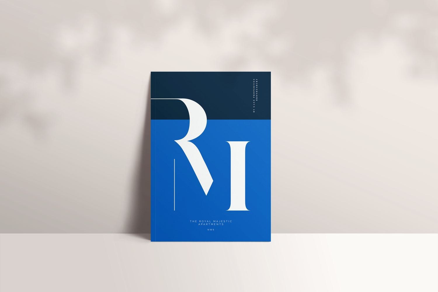 The Royal Majestic brochure cover in navy with the RM monogram, print design by HDEY