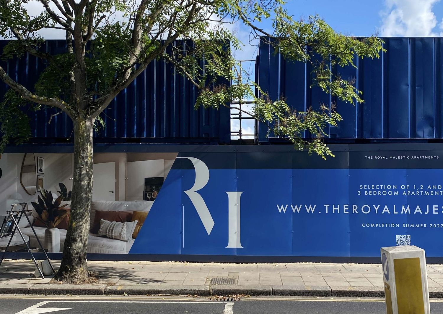 The Royal Majestic site hoarding in navy with the RM monogram, Willesden Lane, London NW6 — by HDEY