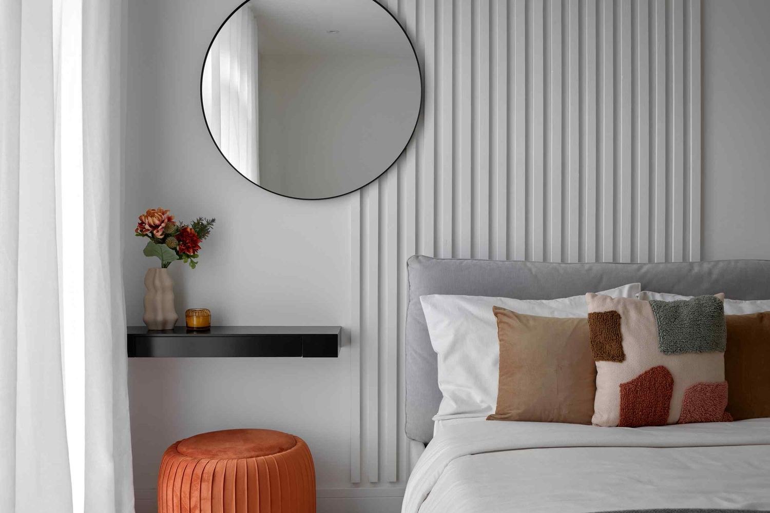 14 St Peter's Road show home bedroom with orange pouffe and round mirror, Croydon — styled by HDEY