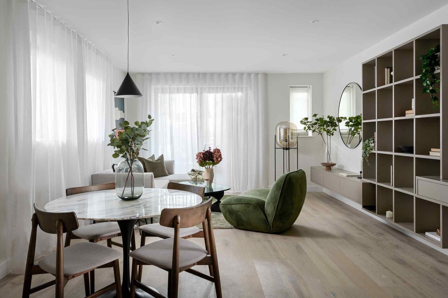 14 St Peter's Road show home living and dining space with green chair and pendant, Croydon — show home styled by HDEY