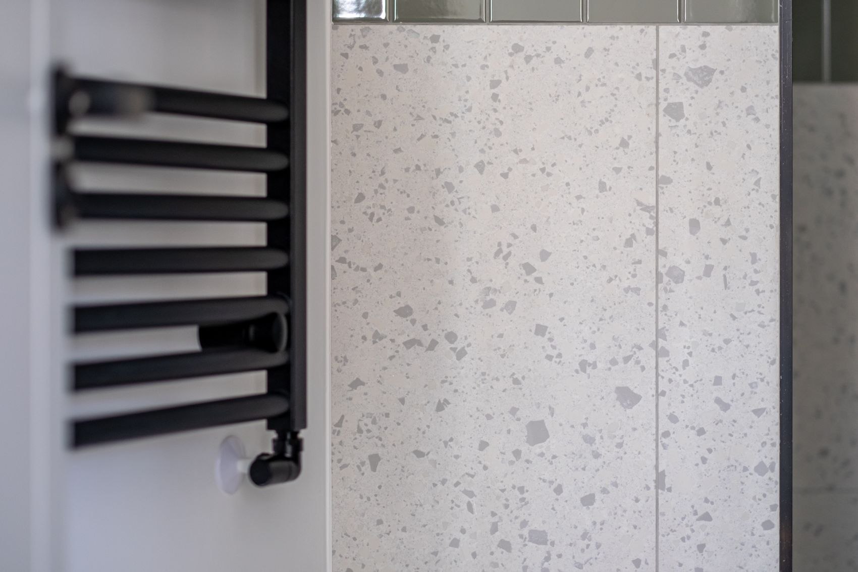 Streatley Road black towel rail against terrazzo tiling, London, specification by HDEY