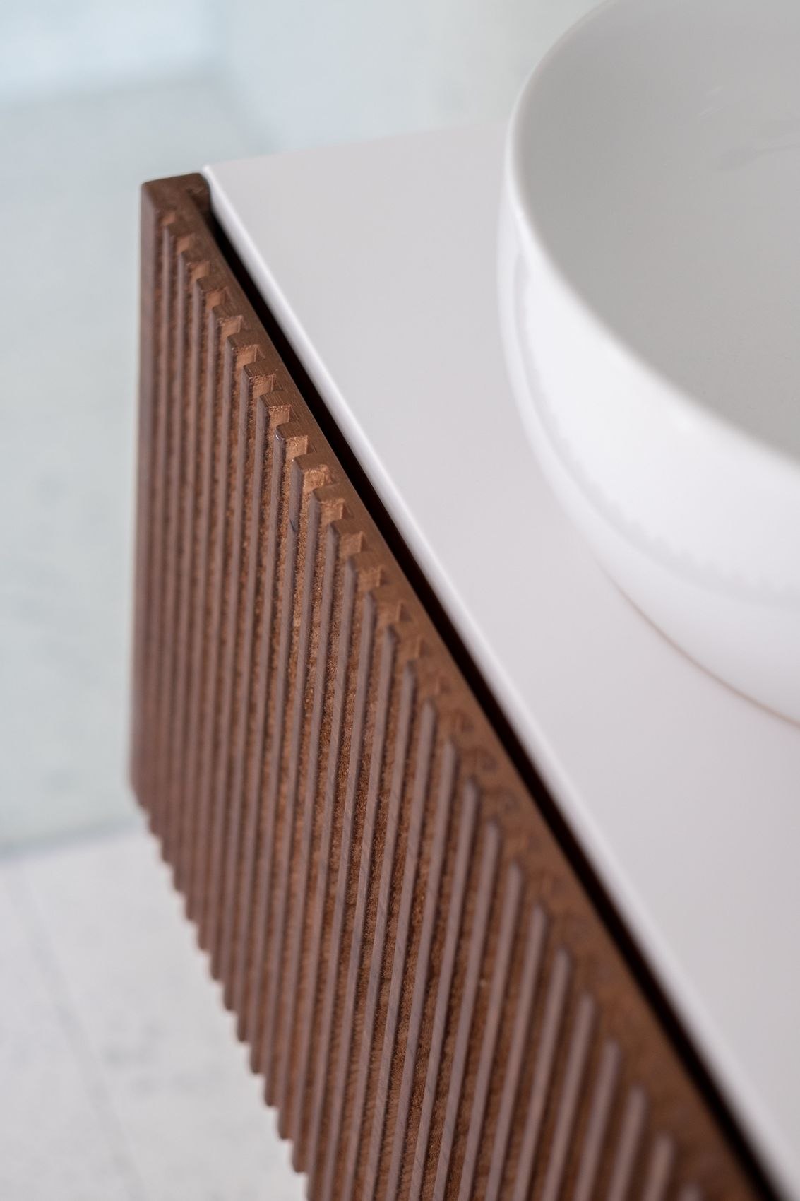 Streatley Road fluted walnut vanity edge detail beneath a round basin, London, by HDEY