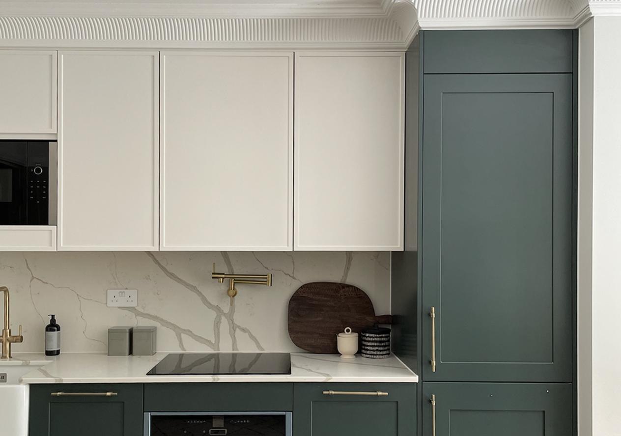 The Carlton kitchen detail with green cabinetry, marble worktop and brass tap, Ealing — by HDEY