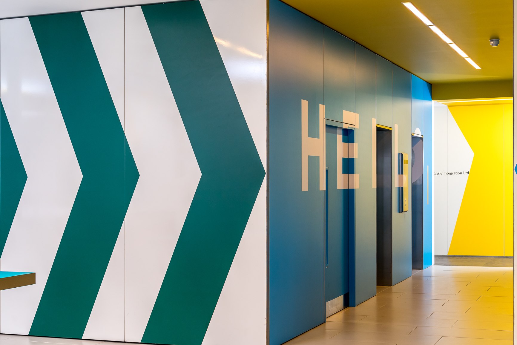 Twenty lift lobby with teal chevrons, a yellow ceiling and HELLO in cut lettering, London Bridge — by HDEY