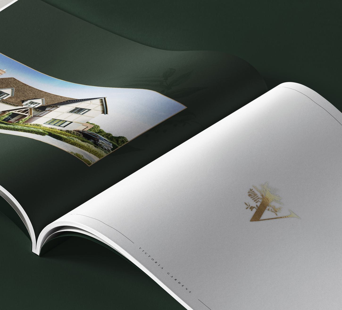Victoria Gardens brochure cover in deep green with gold botanical mark, print design by HDEY