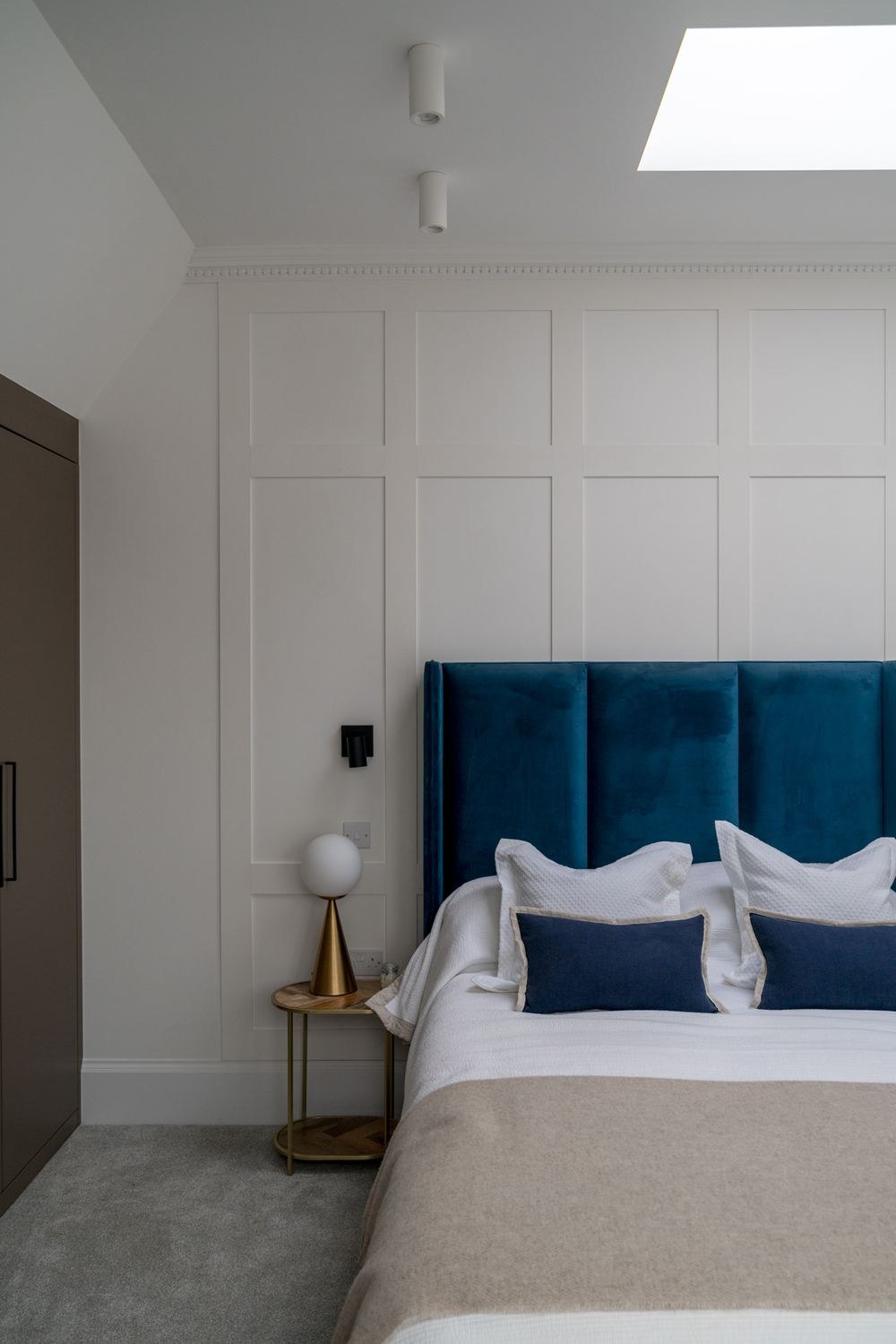 West Lodge principal bedroom with teal velvet headboard and hand-painted wall panelling, Ealing — by HDEY