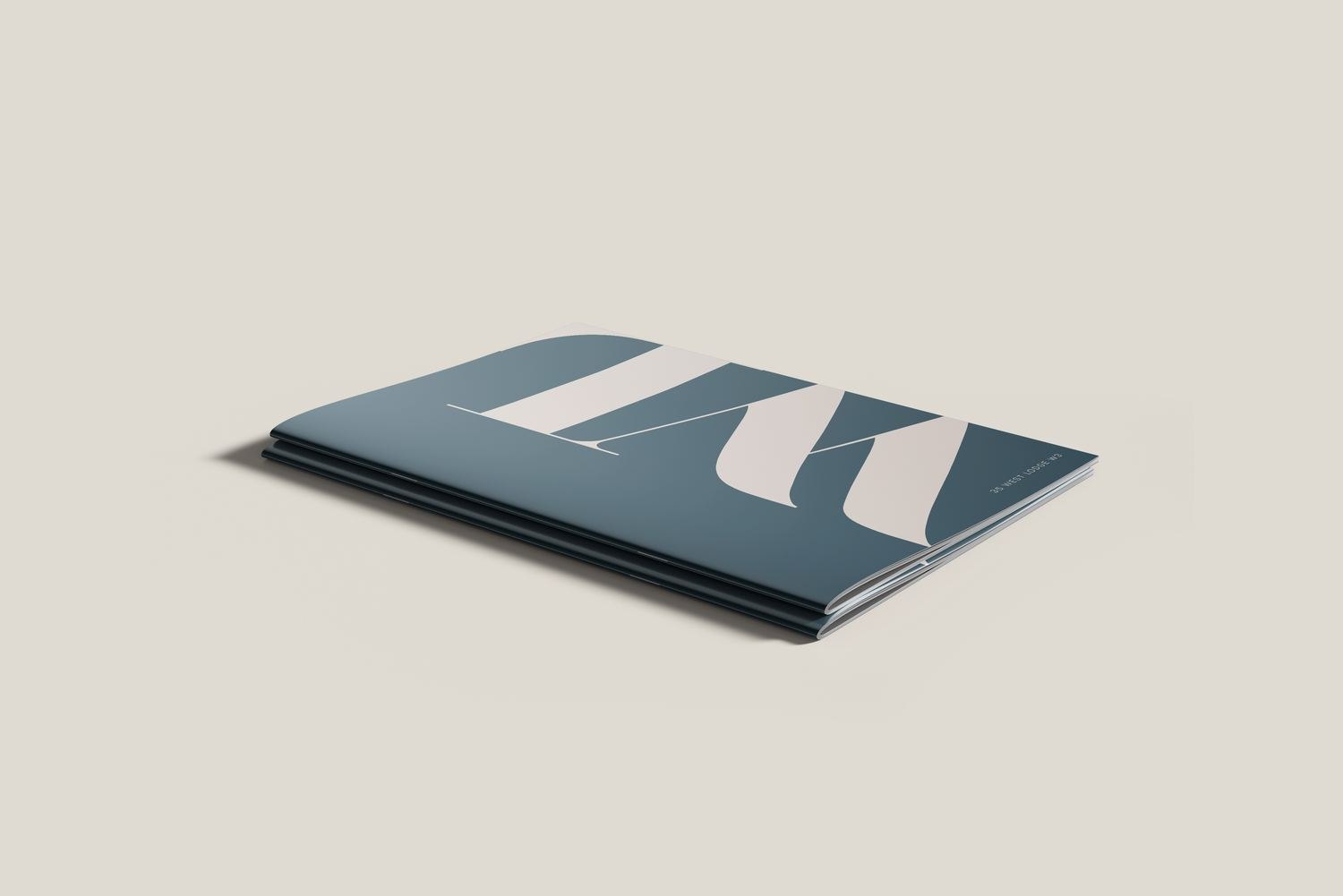 West Lodge brochure lying flat showing the teal cover, print design by HDEY