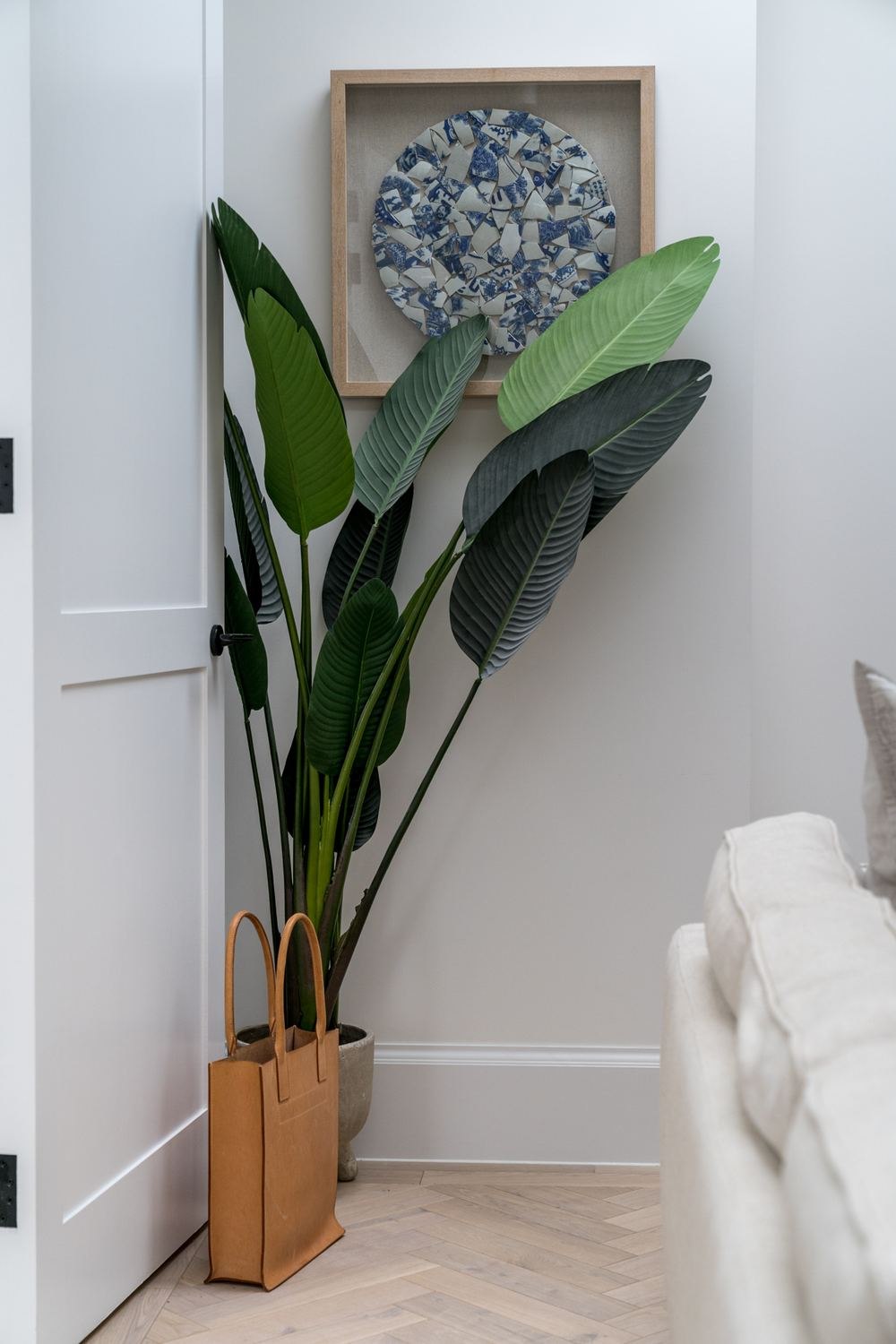 West Lodge apartment hallway with artwork and planting, Ealing — interior design by HDEY