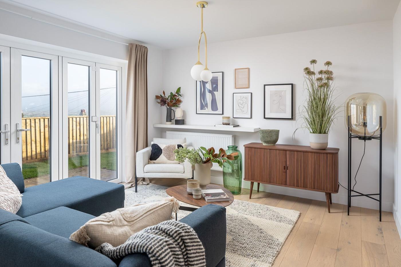 Windmill Park show home living room with teal sofa and open shelving, Launceston — by HDEY